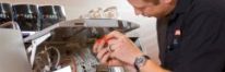 Espresso technician working on a machine